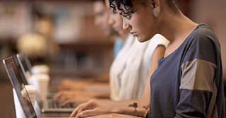 Students taking notes on laptops