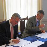 Photo caption: SMCC President Ron Cantor (left) and USM President Glenn Cummings sign a series of new transfer agreements that simplify and streamline the transfer path between selected academic programs at SMCC and corresponding programs USM.