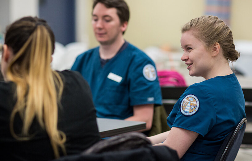 SMCC-health-sciences-students-smiling-at-desk