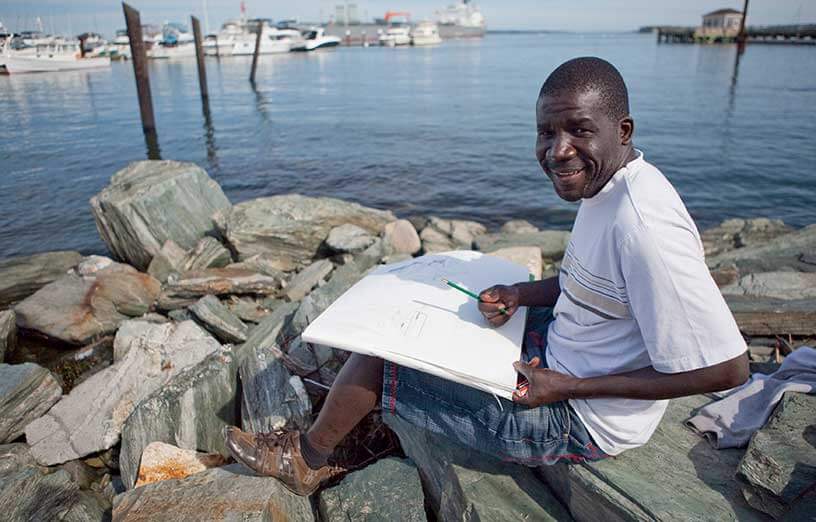 art-student-drawing-by-the-beach-SMCC-Maine