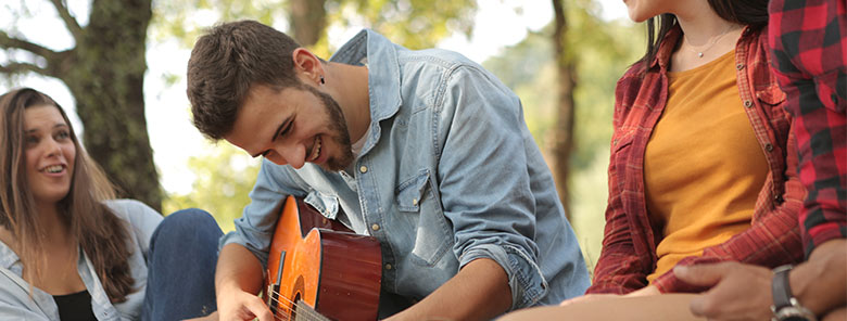 students-smiling-with-acoustic-guitar