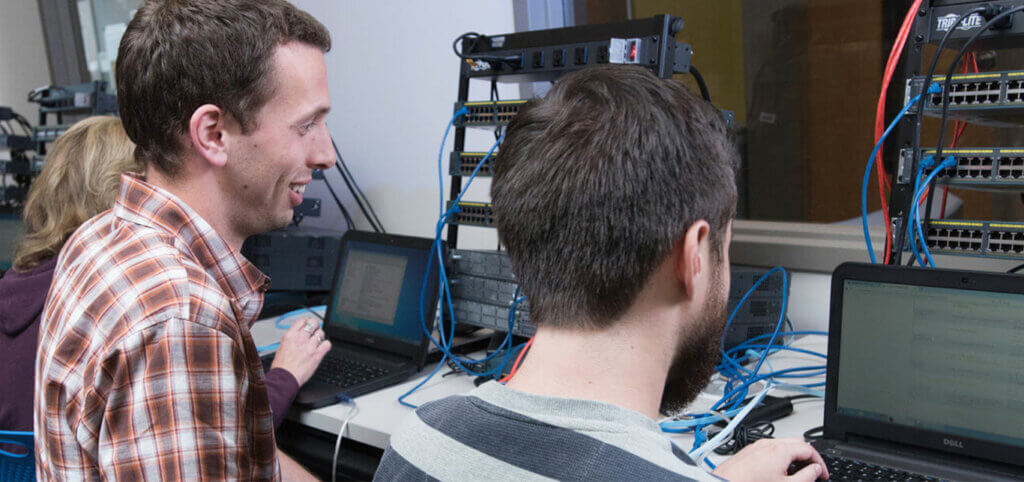 smiling-IT-students-with-computers-SMCC