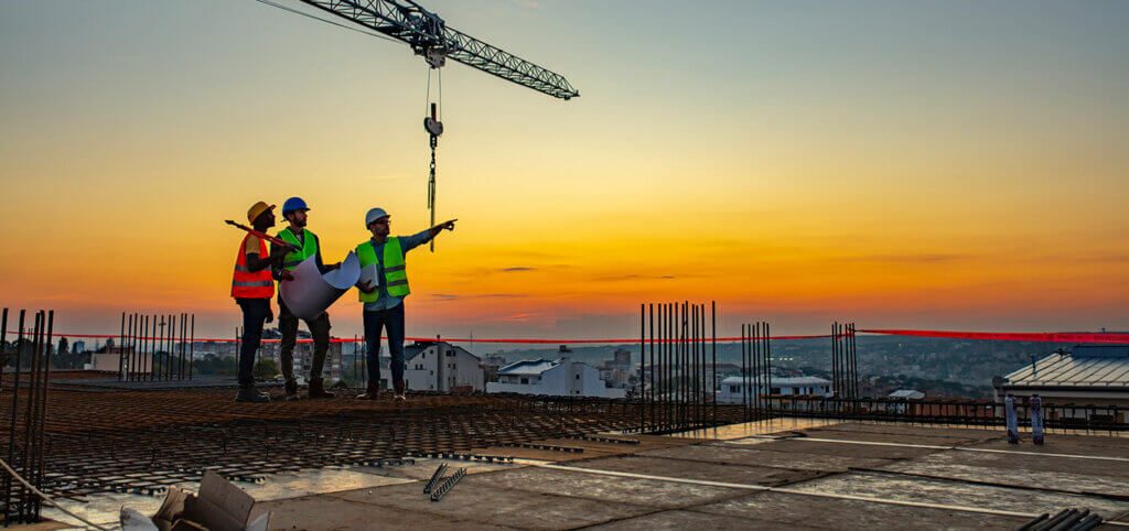 engineers-working-at-sunset-with-crane-in-view