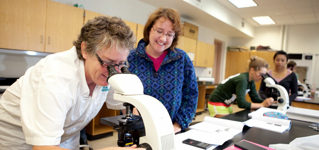 students-and-instructor-with-microscopes-SMCC-Maine