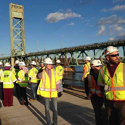 group-of-engineers-with-hard-hats-and-neon-safety-vests