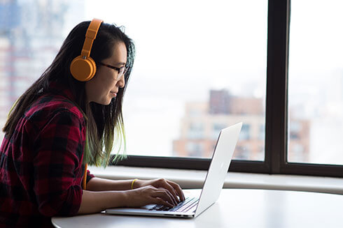 student-with-laptop-and-headphones