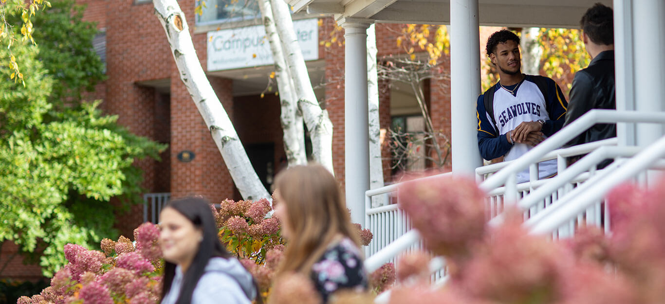 students-at-campus-center-near-birch-trees-and-flowers